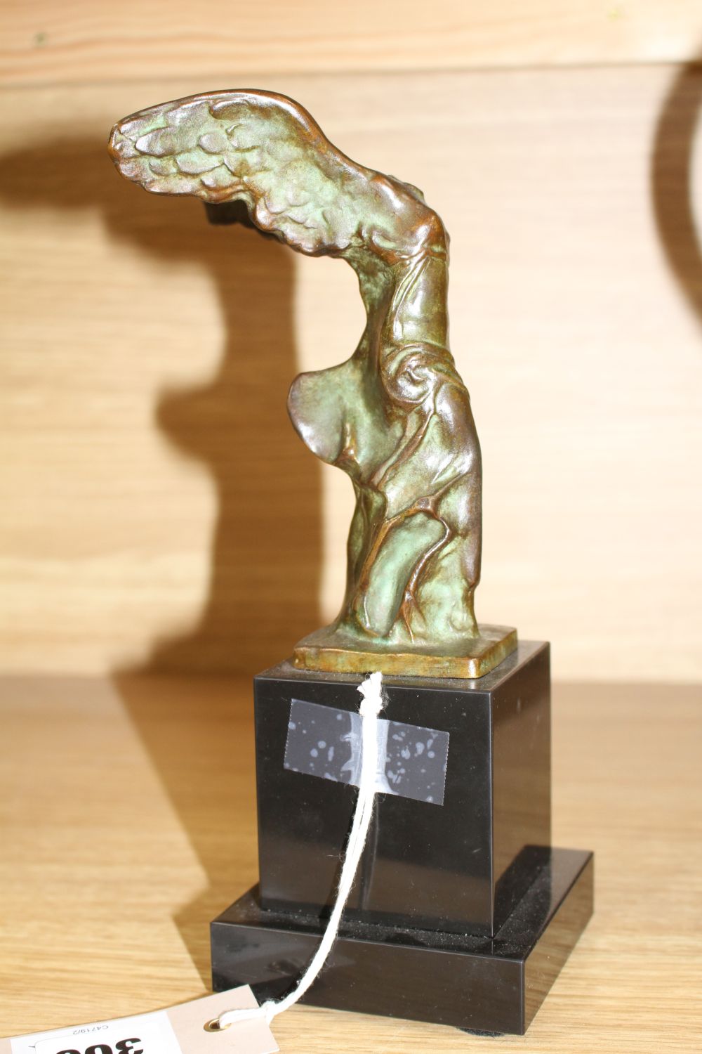 Max Le Verrier (1891-1973). A bronze group La Victoire de Samothrace, on black marble plinth, overall height 23.5cm